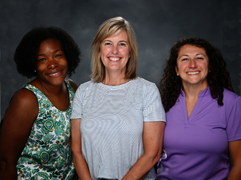 Ms. Schwartz, Mrs. Pohzehl, and Ms. Baran posing for a picture and smiling