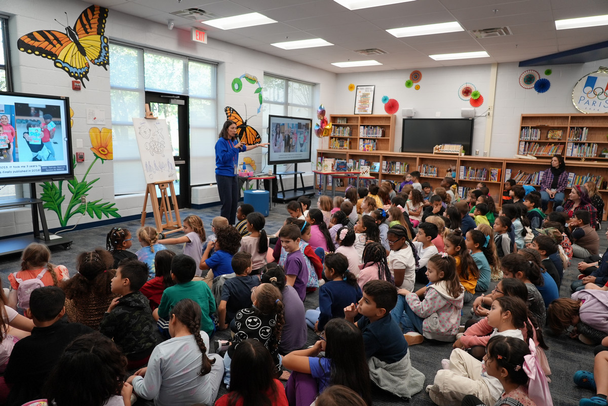 Angela Dominguez speaking to a large group of Bennett students