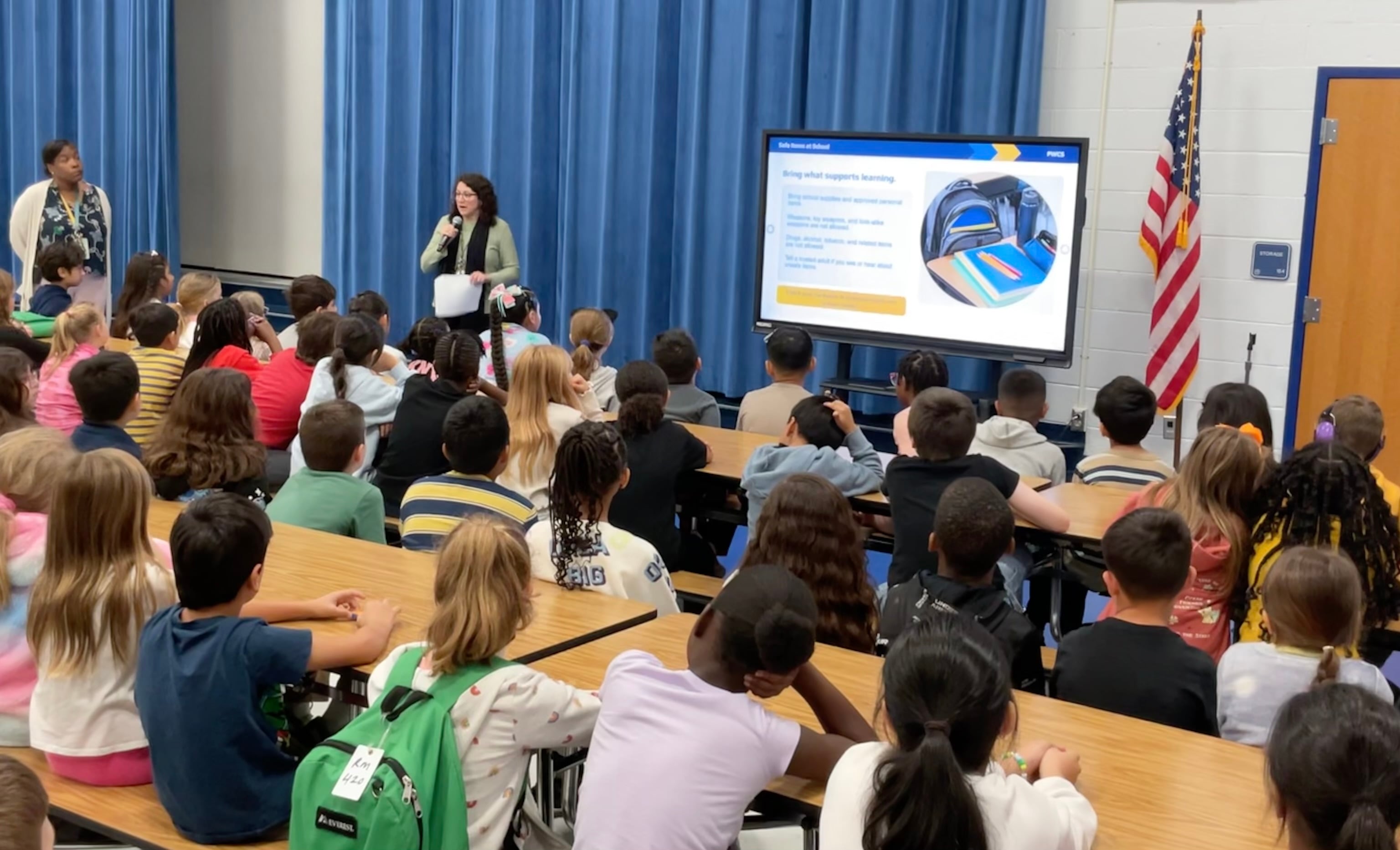 Ms. Baran addressing a group of students at the assembly. 
